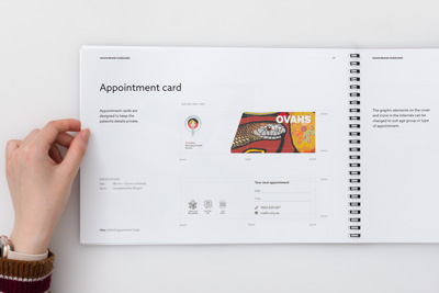 Photograph of page 34 from OVAHS Brand Guidelines showing the design of a folded appointment card with an illustration on the cover and appointment details inside.