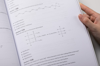 Photo of a page held open to show the layout of multiple-choice questions.