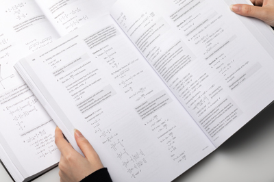 Photo of a page spreads showing worked solutions for exam practice questions.