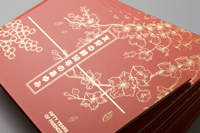 Photo of the cover design showing light reflecting off the gold foil.