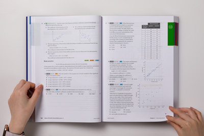 Photo of a page spread showing text, tables and graphs that are proofread during production. 